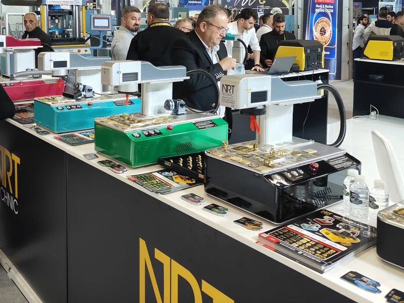 NRT fiber laser marking machines in different colors with visitors at the NRT booth, IJS 2026